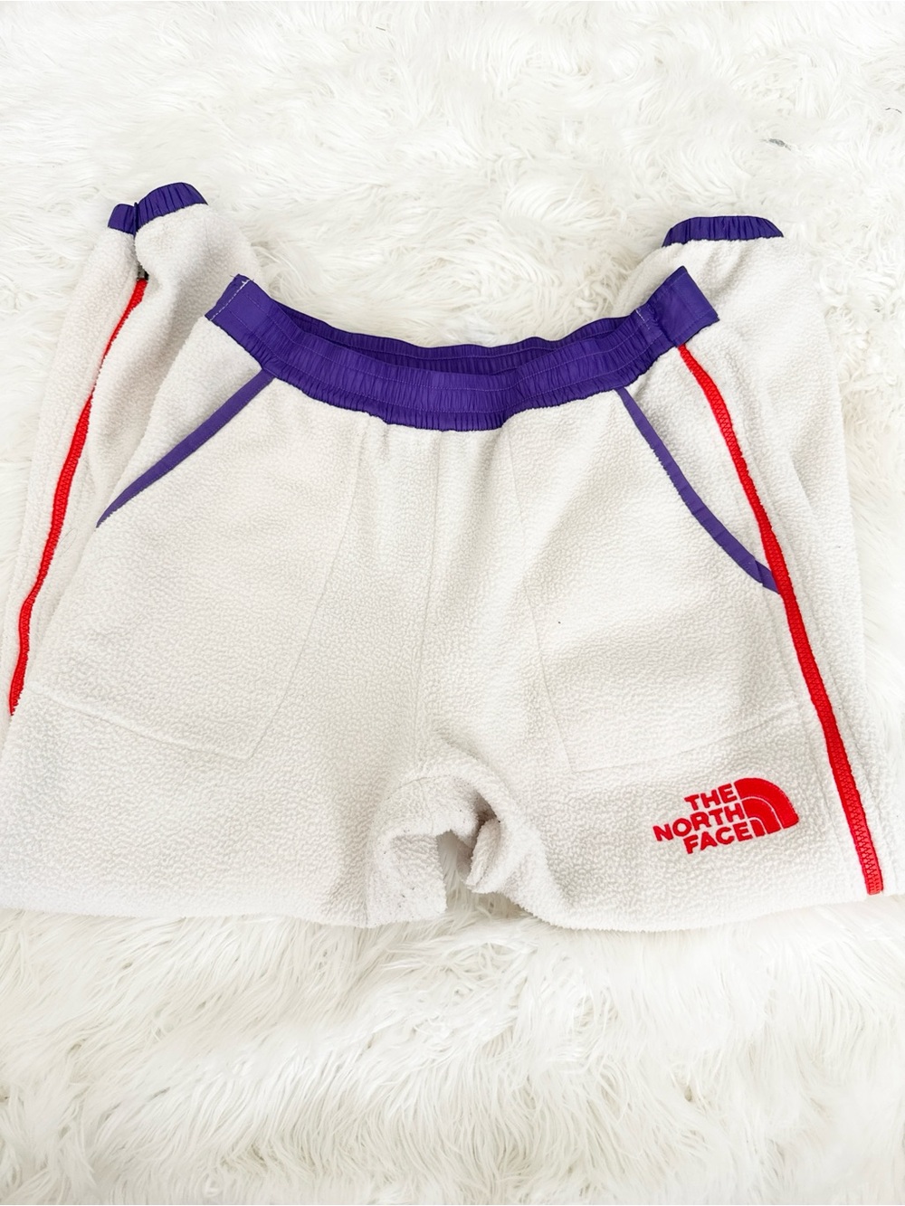 The North Face Kids Cream Fleece Shorts with Purple Waistband and Red Trim